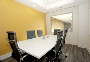 Large private conference or meeting room with table and executive chairs.